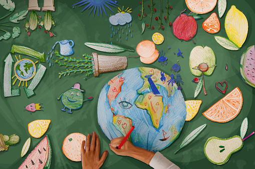 Children's hands drawing the planet earth