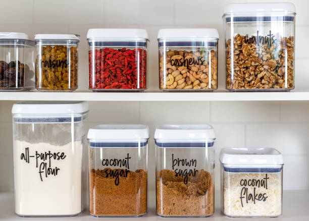 Neatly organized transparent canisters for baking ingredients Neatly organized and labeled baking ingredients in BPA-free plastic storage containers nut food photos stock pictures, royalty-free photos & images