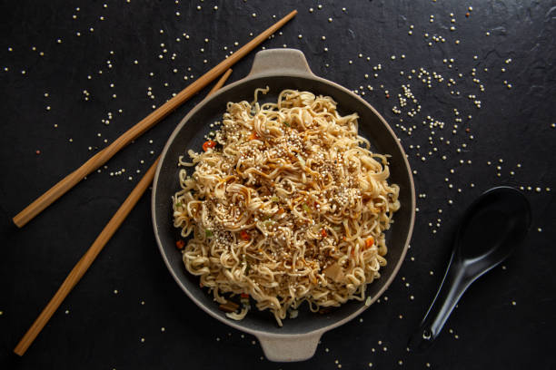 istock Sesame seed teriyaki dish with black sauce on black background 1307980885