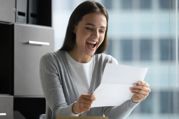 istock Overjoyed young lady reading message confirming full credit payment 1307981071