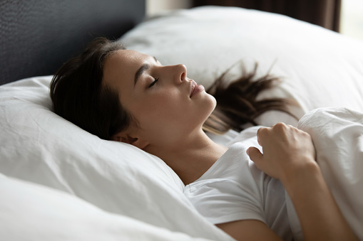 Young woman sleeping in a straw