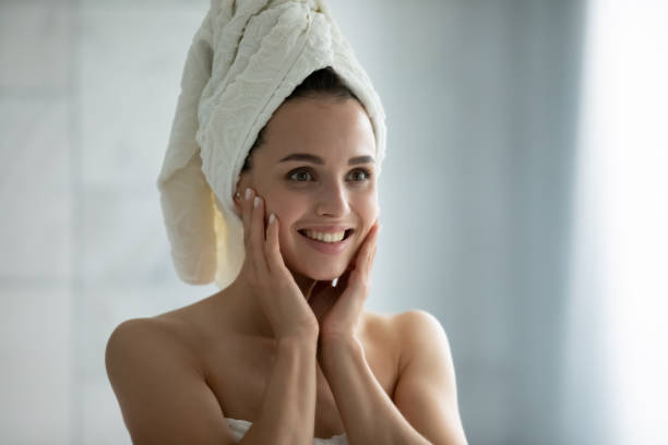 istock Millennial woman looking at mirror after shower satisfied with reflection 1307981151