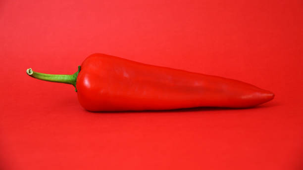 istock red sweet bell pepper paprika on red background 1307982656