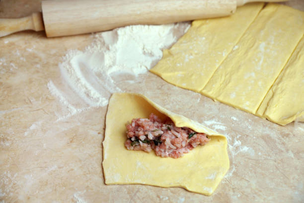 istock cooking pies, minced meat with rice on rolled dough 1307982682
