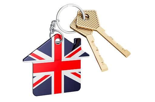 Real estate in the United Kingdom. Home keychain with British flag. Property, rent or mortgage concept. 3D rendering isolated on white background