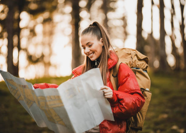 istock Hiker female looking at map for directions 1307984937