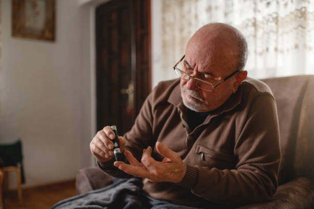 istock Senior men with glucometer checking blood sugar level at home 1307985011
