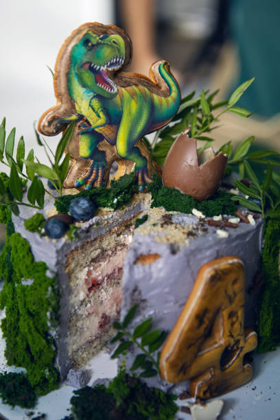 istock green dinosaur cake for four-year-old baby boy with moss 1307986520