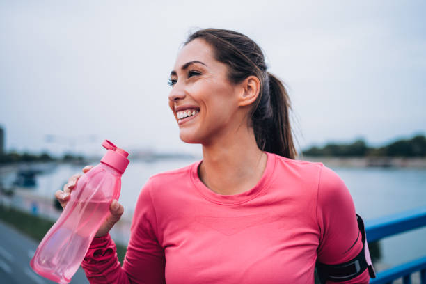 Sporty woman taking a break after running workout.