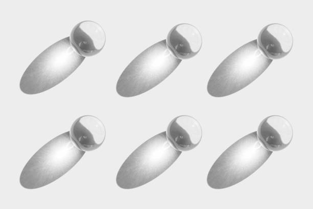 istock Glass transparent ball with sun reflection, light and shadow, sphere pattern on white background. Orb for fortunetelling and predicting the future 1307990933