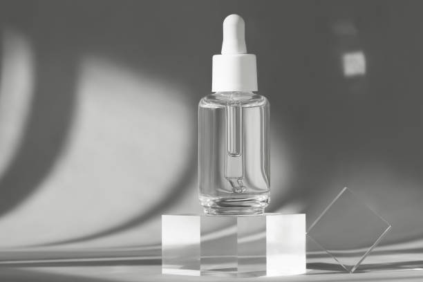 istock Serum bottle with peptides and retinol product packaging on modern acrylic transparent blocks with shadows from sun, cosmetic mockup on geometric stand, pedestal, cosmetics podium 1307992265