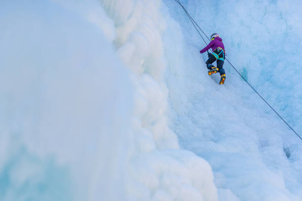 istock Ice climb with ice-axe and rope 1307993917