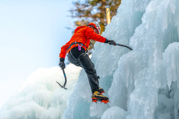 istock Ice climb with ice-axe and rope 1307993932