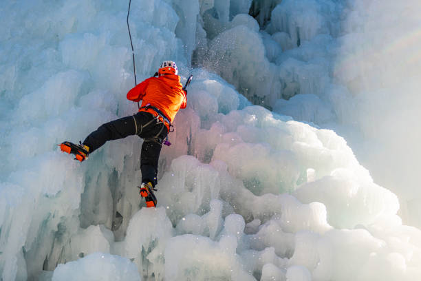 istock Ice climb with ice-axe and rope 1307993944