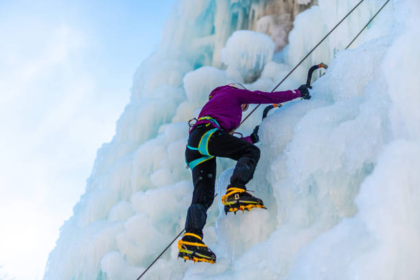 istock Ice climb with ice-axe and rope 1307993946