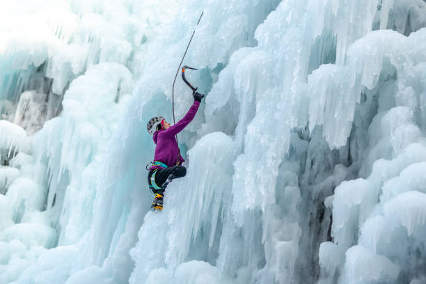 istock Ice climb with ice-axe and rope 1307994022