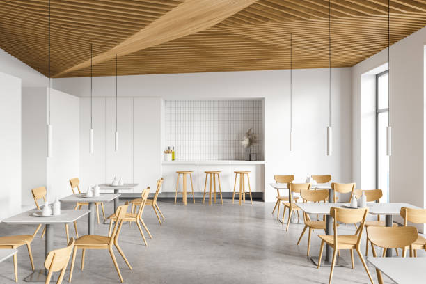 istock Modern white cafe interior with bar counter and tables 1307995001