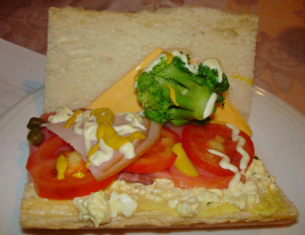 Ham and cheese sandwich with tomatoes and brocolli
