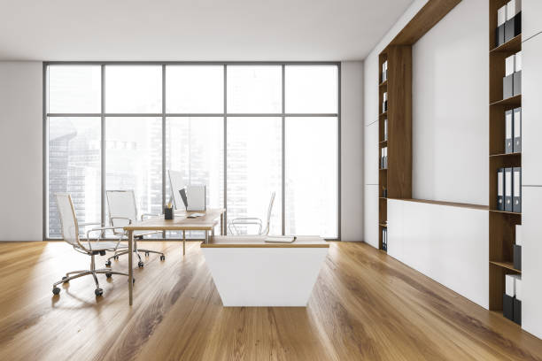 istock White office room with chairs, table and computer, parquet floor with shelf 1307995467