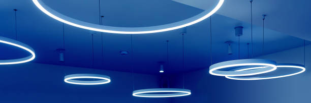 istock Ceiling with round modern LED lamps. Suspended fluorescent lights under the ceiling. Careful energy consumption, energy saving concept 1307996359