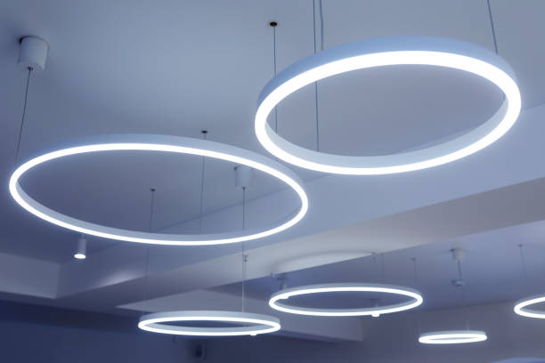 istock Ceiling with round modern LED lamps. Suspended fluorescent lights under the ceiling. Careful energy consumption, energy saving concept 1307996360
