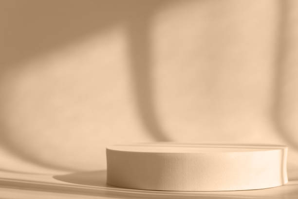 istock Cosmetic product presentation with shadows and light. Beige backdrop with round podium, display, mockup. Window natural shadow overlay effect on purple surface 1307996410
