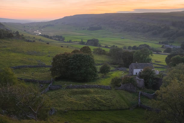 Ingleborough, Yorkshire Dales Colourful, sunrise or sunset sky over the rural countryside landscape and farmland of Ingleborough Valley in the Yorkshire Dales National Park, UK. ingleborough stock pictures, royalty-free photos & images