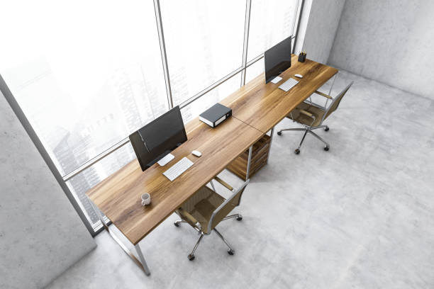istock Top view of white business room with computers near window 1307997565