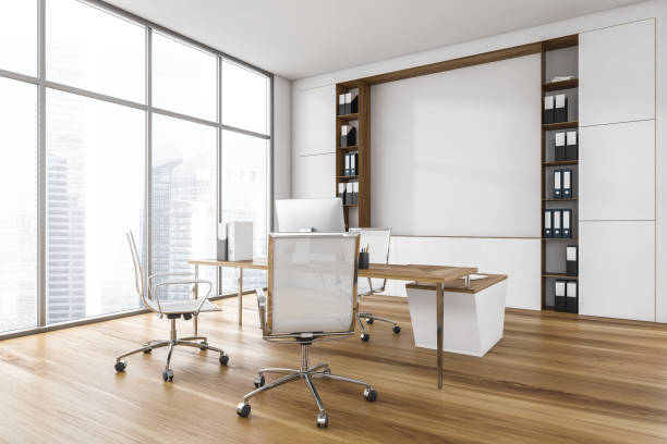 istock White office room with chairs, table and computer, parquet floor with shelf 1307998567