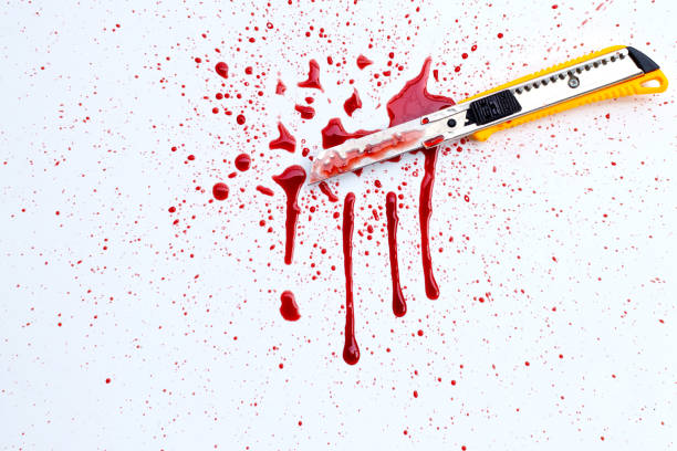 istock Stationery knife with blood on white 1307999633