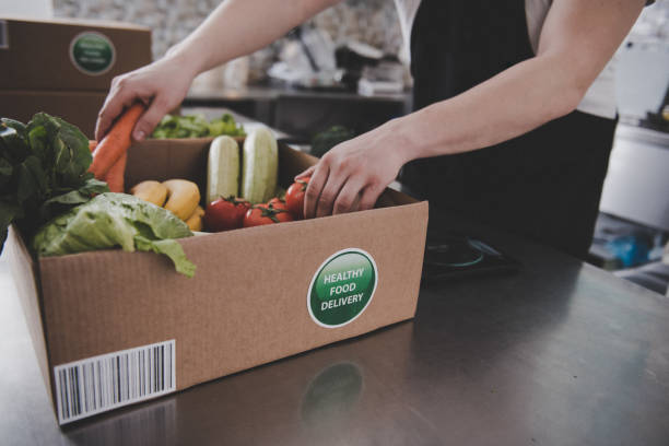 istock Cardboard boxes being filled with food for delivery 1308001676