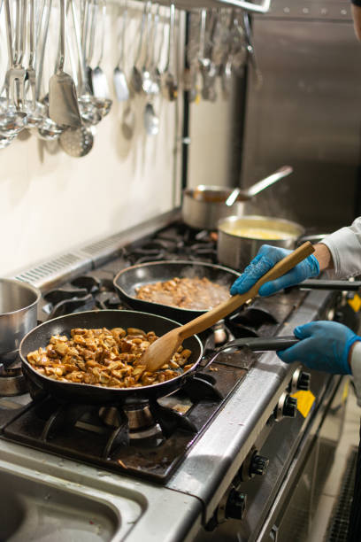 istock Chefs in restaurant kitchen at stove with pan 1308006471