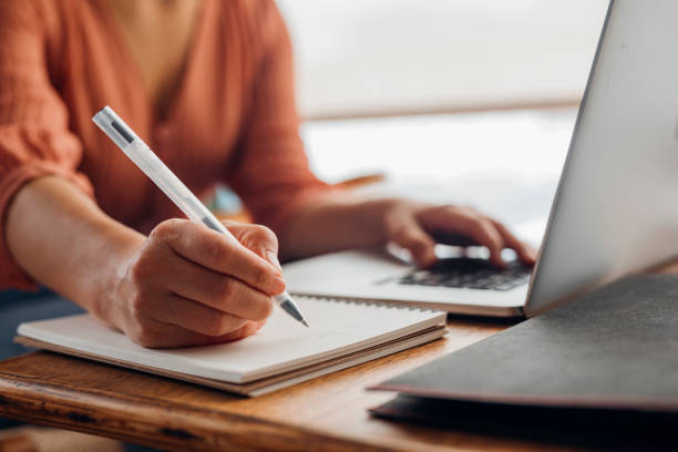 istock Women in Business: Anonymous Young Businesswoman Using a Laptop While Working from Home 1308007219