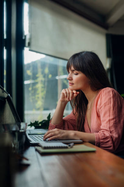istock Women in Business: Attractive Businesswoman Using a Laptop while Working from Home 1308007243