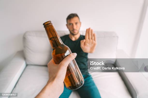 No Alcohol Healthy Lifestyle Young Man Refuses To Drink Beer Making Stop Gesture To Bottle Of Beer Stock Photo - Download Image Now