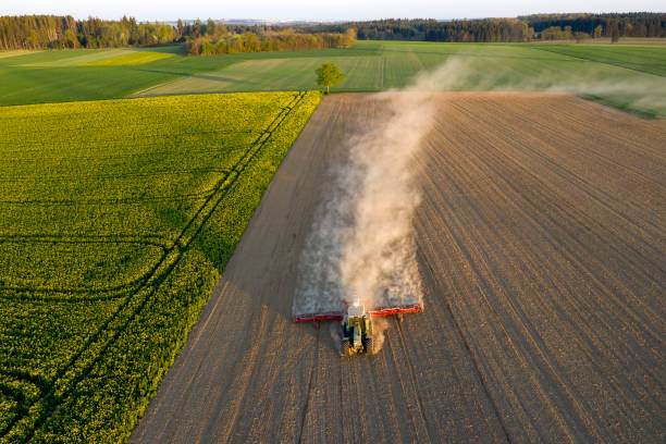 istock Aerial view of a tractor sowing field 1308012350