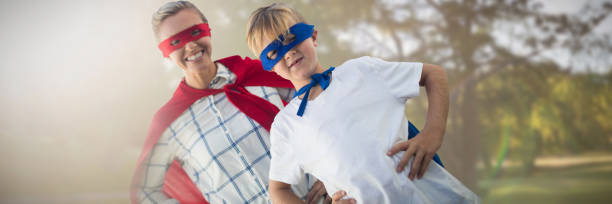 Composite image of mother and son pretending to be superhero Mother and son pretending to be superhero against park on sunny day superhero environment women green color stock pictures, royalty-free photos & images