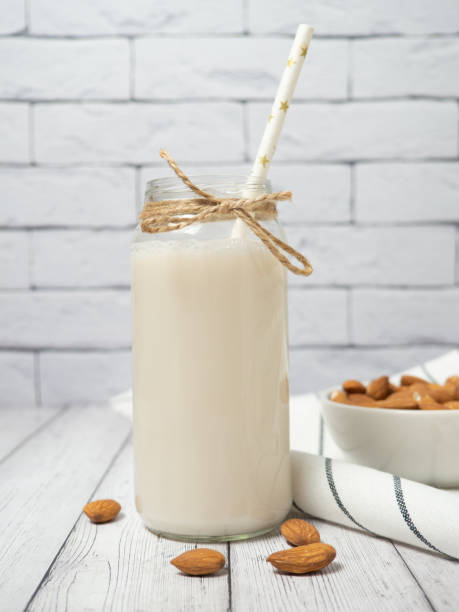 istock nuts almonds and almond milk on a white wooden table 1308016393