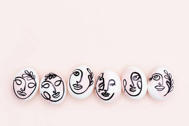 Happy Easter concept. Surreal faces on eggs on pink background. Art und Online style. Top view Flat lay Copy space.