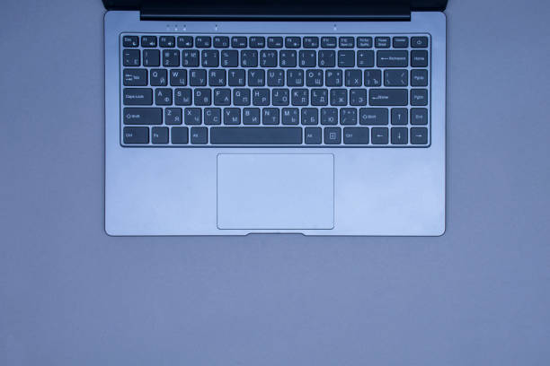 istock Open laptop with keyboard on a gray background. Top view. 1308017957
