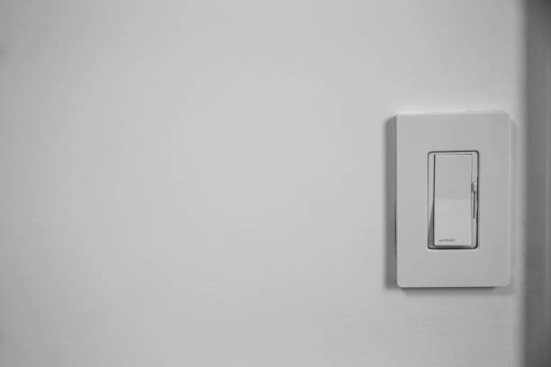Single light switch dimmer on a white wall with space for text Single light switch dimmer on a white wall with space for text dimmer switch photos stock pictures, royalty-free photos & images