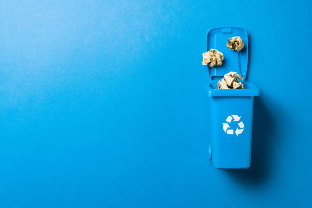 istock Trash bin. Blue dustbin for recycle paper trash isolated on blue background. Container for disposal garbage waste and save environment. 1308022612