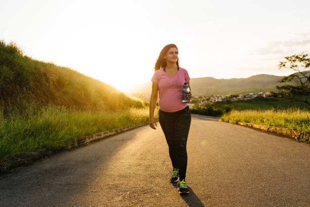 istock Woman walking at sunset 1308025920