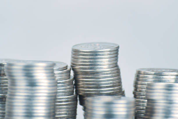istock Stacks of silver coins on white background. 1308026010