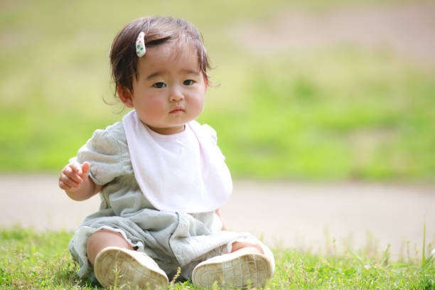 istock Baby sitting on the lawn 1308029132