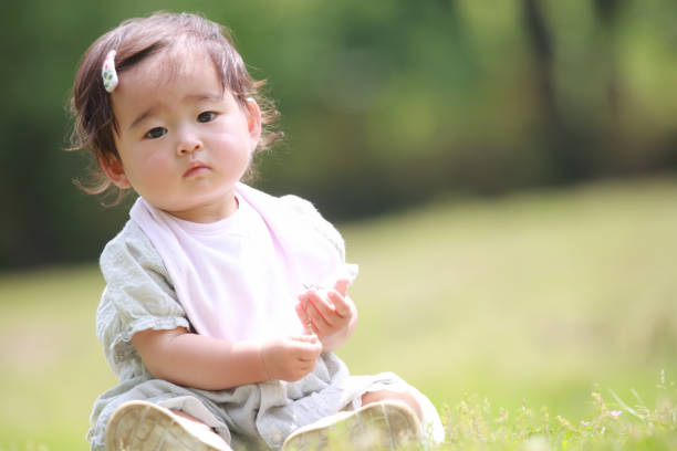 istock Baby sitting on the lawn 1308029143
