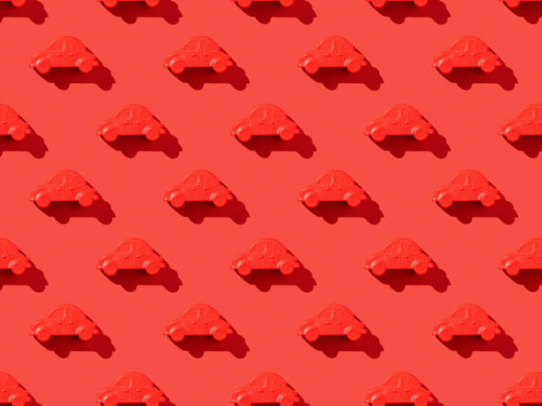 istock A pattern of red cars on a bright red background. 1308029261
