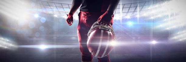 istock Composite image of volleyball player holding rugby helmet 1308037256