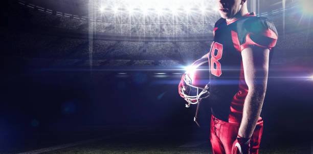 istock Composite image of volleyball player holding rugby helmet 1308037327