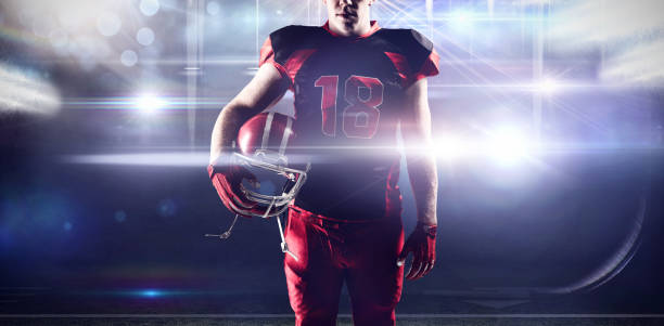 istock Composite image of volleyball player holding rugby helmet 1308037332